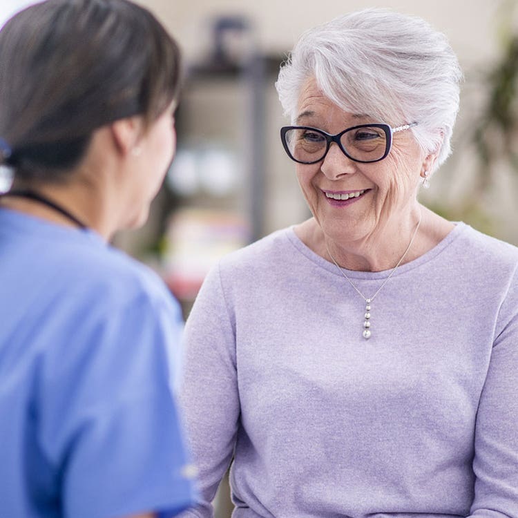 Older women speaks with physician