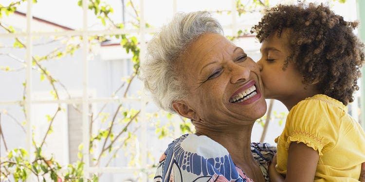 Granddaughter kisses Grandmother on cheek