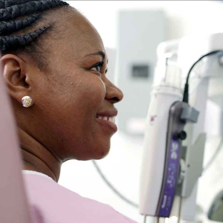 smiling woman prepares for breast biopsy