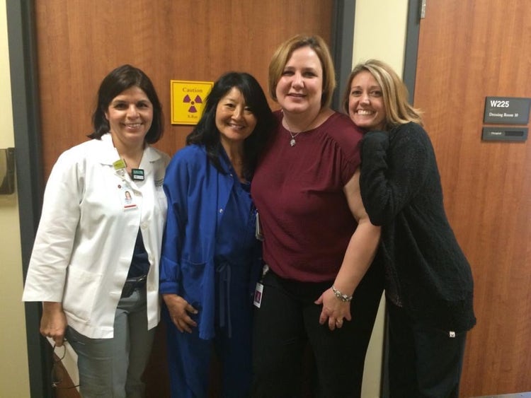 Four women clinicians pose for a photograph