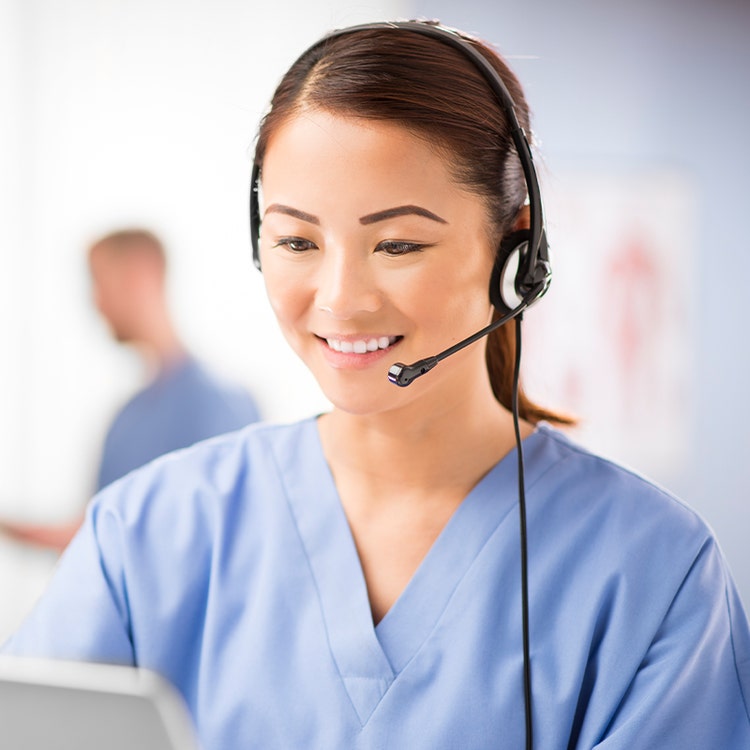 woman in scrubs wearing a headset with microphone