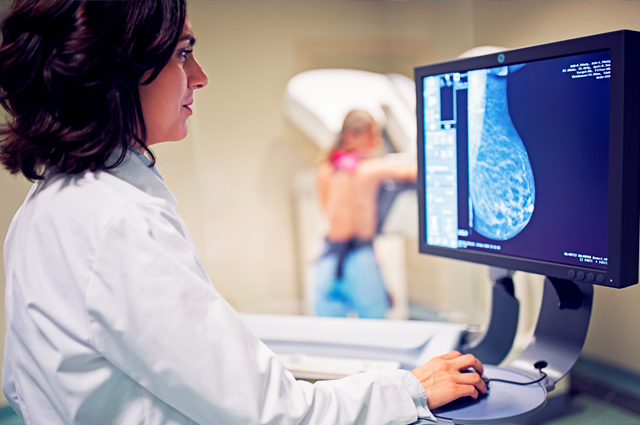 A physician performs a mammogram screening for breast cancer