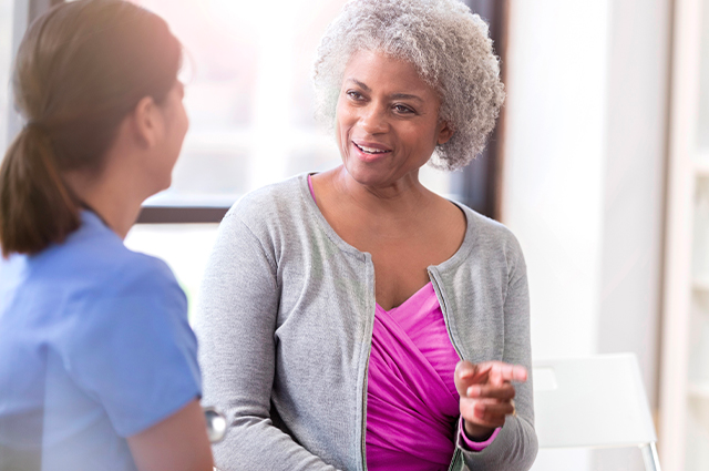 A patient discussing their breast biopsy with her physician