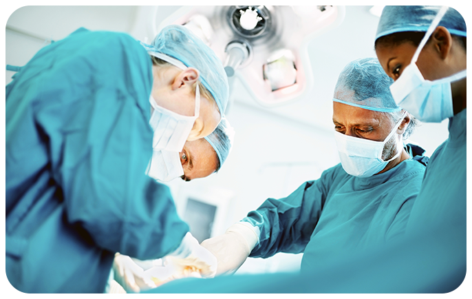Surgeons perform surgery in an operating room
