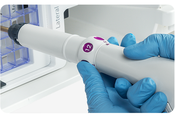 Gloved hands adjust aperture with probe knob on Mammotome Prima probe