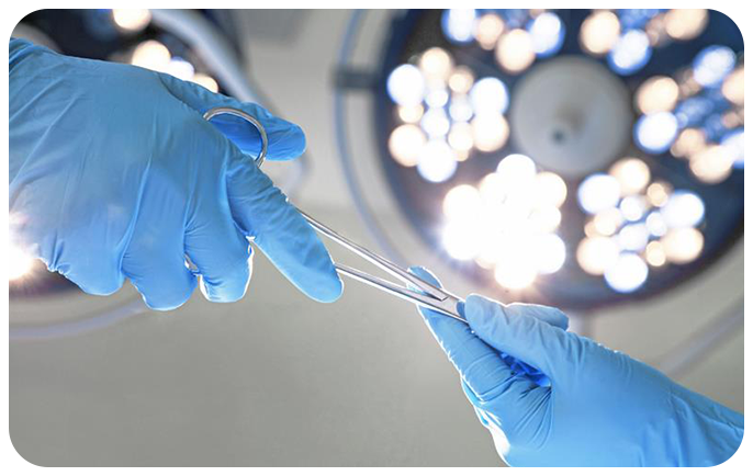 gloved hands exchange surgical tools in an operating room